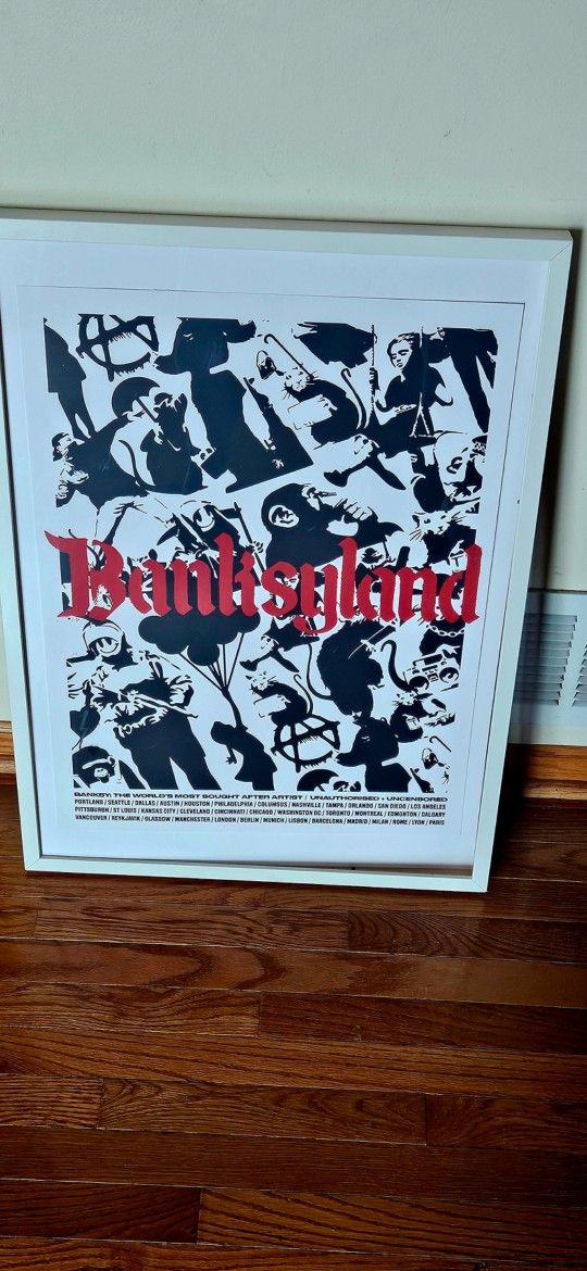 Banksyland Limited Edition Print. From the Philadelphia Banksyland Exclusive Show on 9/2/2022. Comes in a glass picture frame firm.
