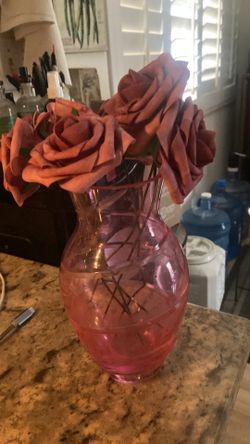 Pink glass vase with artificial flowers