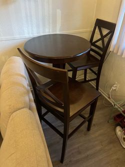 Wooden table with two chairs