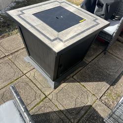 Gas fire pit with clear rocks and cover can be used as a table or fire pit heavy