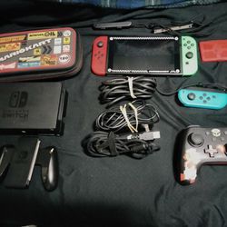 NINTENDO SWITCH WITH PRO CONTROLLER, EXTRA JOY CON,AND TRAVEL CASE.