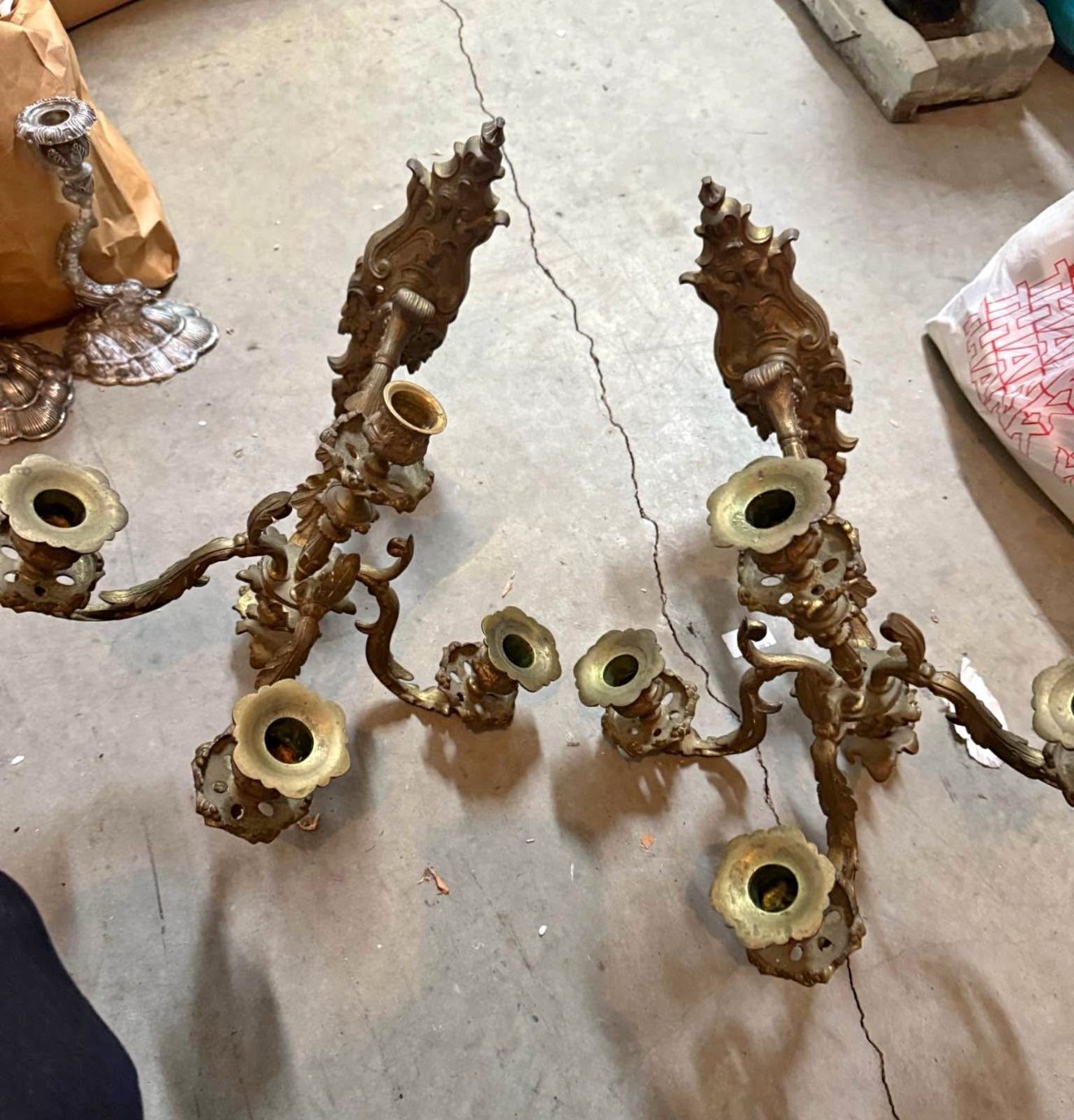 Ornate antique French Rococo-style brass candelabras.  Candelabras, designed to hold multiple candles, have been a symbol of wealth and status since a
