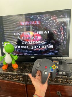 Selling an N64 console with original cables, original controller, and the game Turok 2.