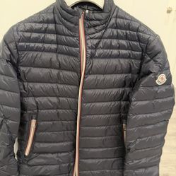 Moncler Daniel short down jacket, featuring a lightweight nylon construction and a tricolor zipper motif inspired by the French flag
