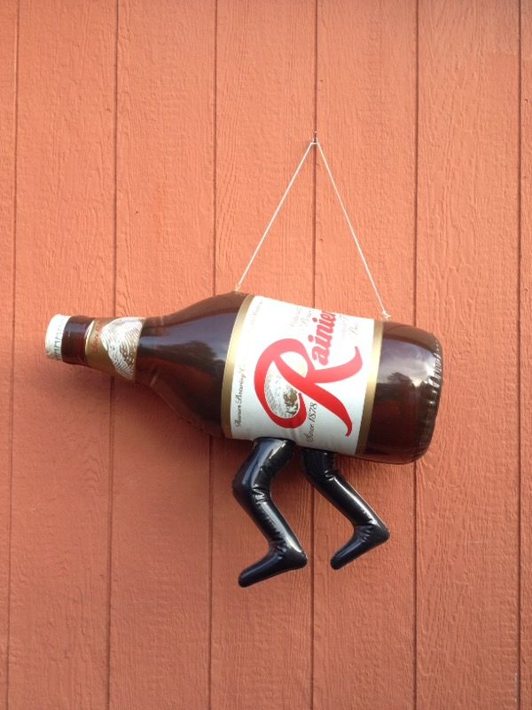 Vintage rainier beer bottle sign with legs
