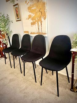 4 black upholstered mid century modern bucket chairs made by Nuo YiEr Display Rack Co. Great condition and recently cleaned.
