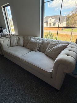 Tufted beige couch from living spaces