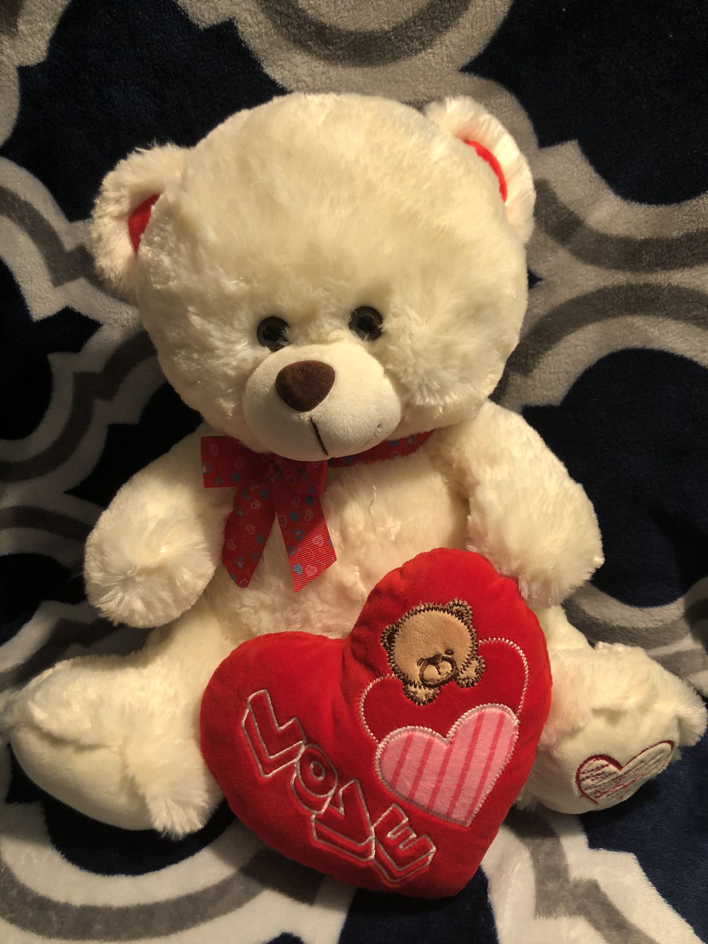 Cream colored teddy bear with heart