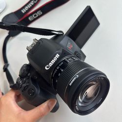 Canon EOS Rebel T8i W/ extra batteries and charger and it came with a 18-55mm lens.