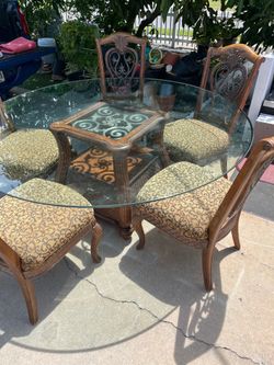A very nice antique round glass and hardwood dining set in very good condition; a cleaning would make it look like new. It comes with 5 excellent, stu
