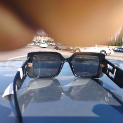 , these are Versace VE4479U sunglasses in black shiny with grey lenses