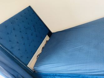 Blue bed with mattress