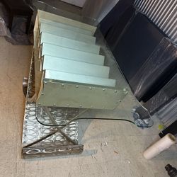 Glass table with a decorative metal base