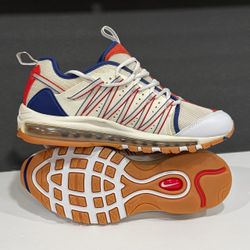 Nike Men's Cream, Blue & Orange Air-Cushioned Sneakers. Nike sneakers with cream mesh upper and blue trim. Orange accents on tongue, heel, and outsole