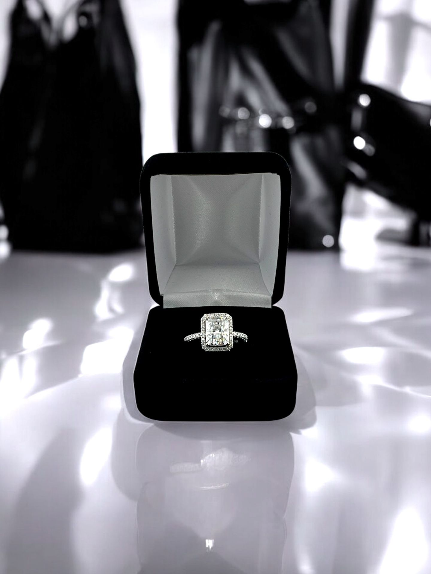10kt White Gold with Radiant Center Cut Moissanite and Small Round Clear Stones Ring.