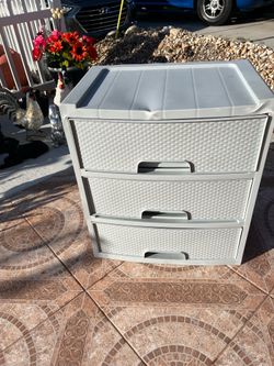 3-drawer plastic chest; there is a small dent on the top, but the drawers open and close properly. It measures 25 1/2 inches high, 22 1/2 inches wide,