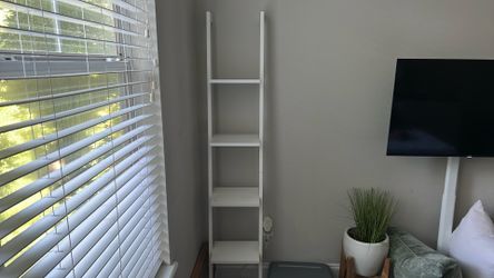 White leaning bookshelf