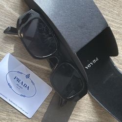 Prada Symbole sunglasses (Model PR 17WS) featuring a polished black frame and dark grey lenses