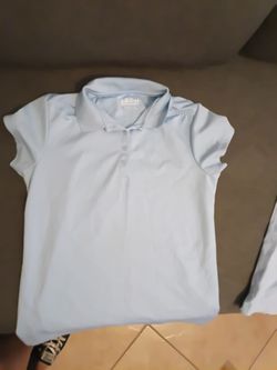 Two light blue uniform shirts