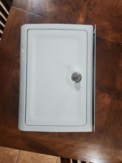 White metal wall-mount mailbox with key