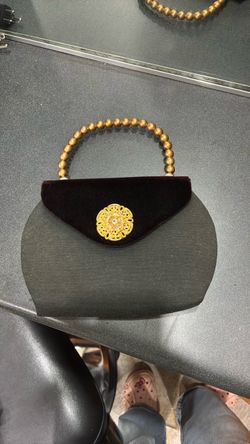 Vintage mid-century silhouette with a black velvet/velveteen triangular top flap, a plain fabric or felted body, and a structured gold-tone beaded top