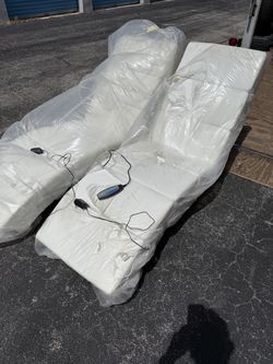 Two white chaise massage chairs