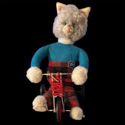 vintage MCM pull-toy featuring a plush cat on a tricycle, likely from the 1950s