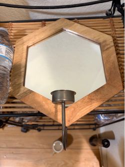 Small wood mirror with candle in front