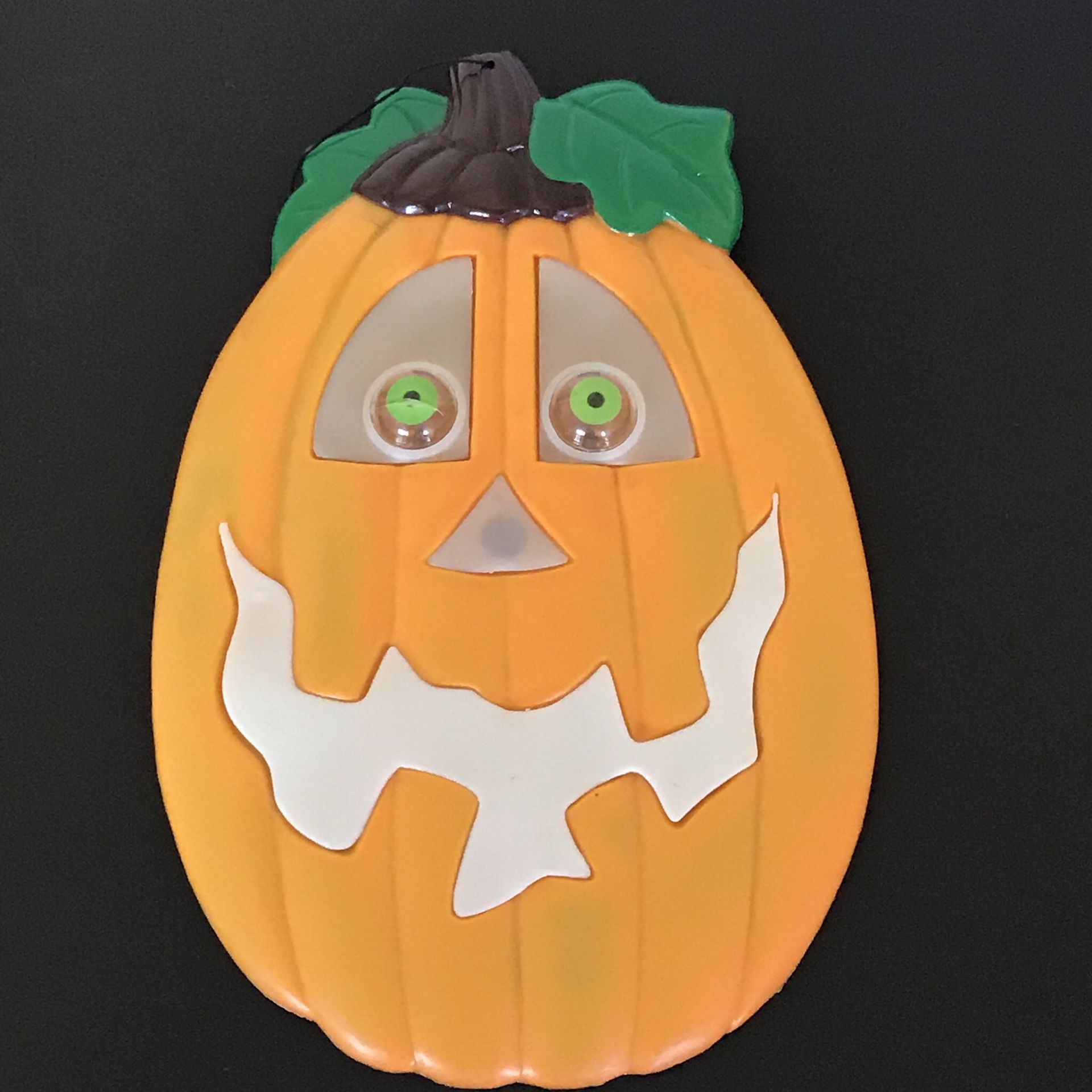 Halloween Pumpkin 1973 Plastic Window Decor hangs by a suction cup requires 1 as battery not included only 1 eye lights up to turn off have to take t