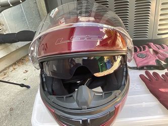 LS2 full-face or modular motorcycle helmet featuring a dual-visor design with a built-in drop-down inner sun shield.
