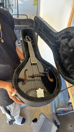 This is a black A-style acoustic mandolin a Rogue RM-100A