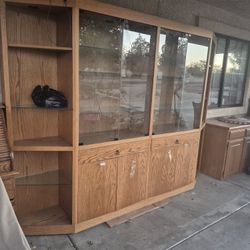 large wooden china or display cabinet with glass and doors. 