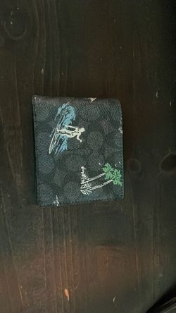 A black Coach wallet Hawaiian style