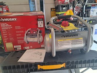 Husky2 Gal.​ 135 PSI Portable Electric Oil-​Free Quiet Jobsite Air Compressor with Dual Pressure Gauges and 1-​Quick Coupler