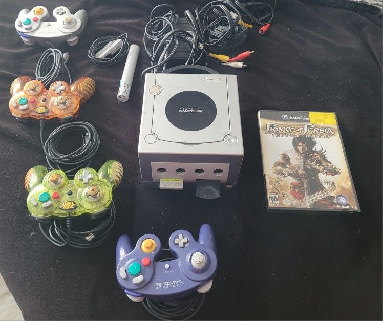 Nintendo gamecube w/ 4 controllers, a microphone, 2 memory cards, and game
