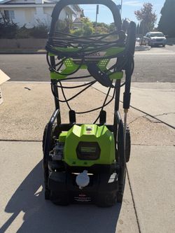 Powerful Greenworks Elite electric pressure washer is a 2000 PSI, 1.2 GPM cleaning tool. This unit has a lime green and black plastic housing with a b