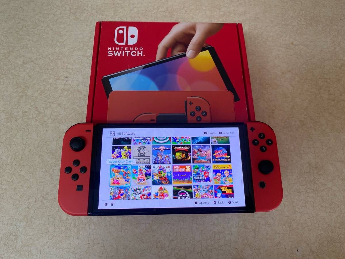 NINTENDO SWITCH OLED with 100 SWITCH GAMES MARIO PARTY,POKEMON,ZELDA,MINECRAFT,LUIGIS MANSION and Many More