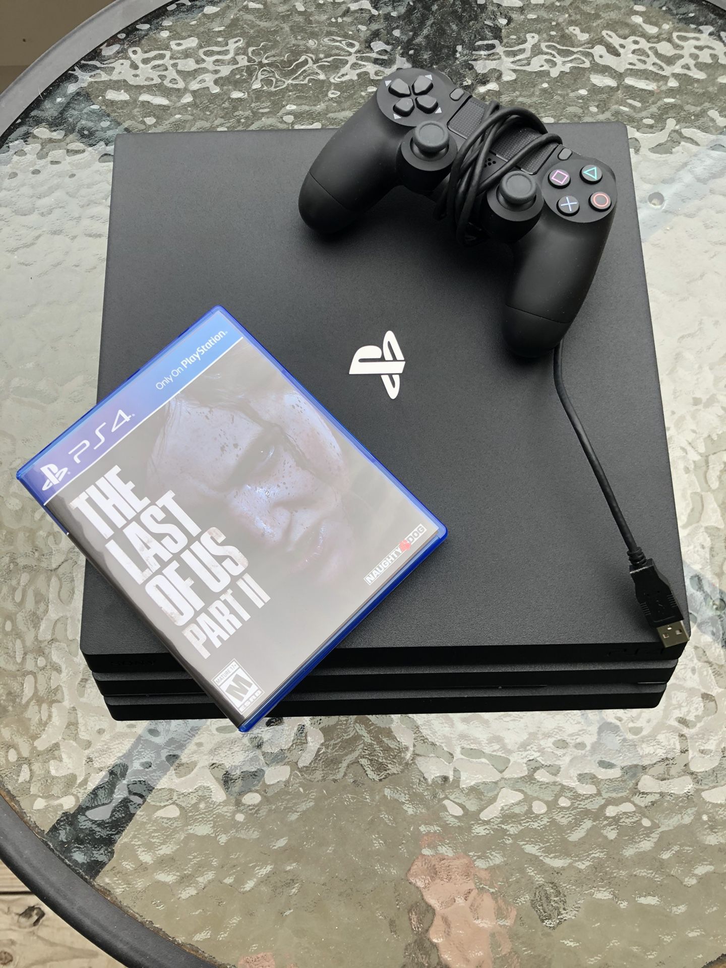 PS4 pro with controller and the last of us part2