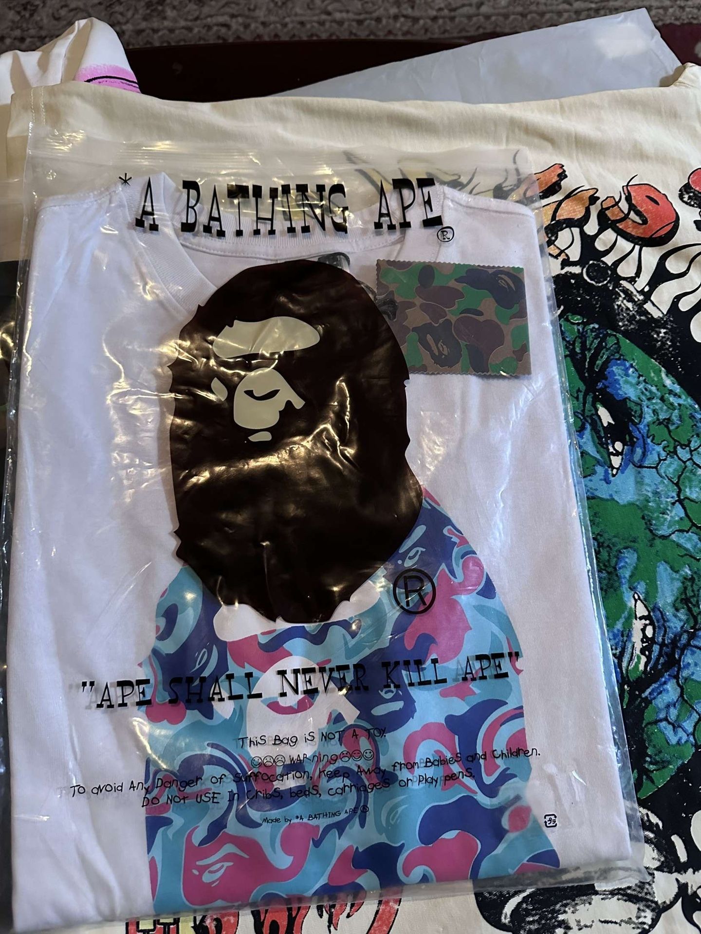 white and blue bape tee