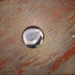 This item is a polished gemstone sphere, likely a Black Agate Geode.