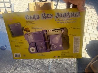 New in box purple electronic journal. This set includes a personal ID card to open the journal, a pop-up reading light, a notebook, an address book