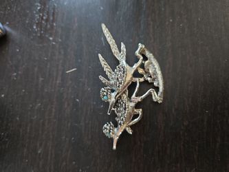 vintage silver-tone brooch featuring two stylized roadrunners with faux turquoise eyes.