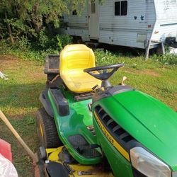 John Deere Tractor(Mower) With trailer that  dumps  also with seed spreader. All For 500.Needs Some Simple Repairs. 