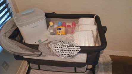 Baby bundle, bassinet, bottle sterilizer, bottles, bibs, baby bathtub, new diapers total for everything 40.00!