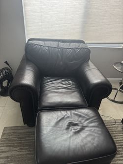 Two Dark Brown Leather Chairs With Ottomans