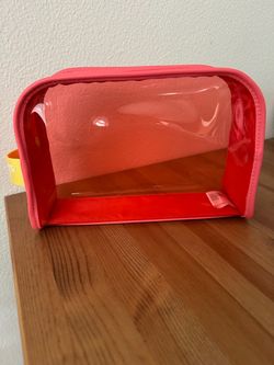 Like new Victoria's Secret clear makeup bag in coral pink. Transparent panels, sturdy zipper with VS