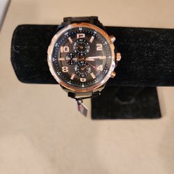 This is a brandnew Curren 8276, leisure-style men's  wristwatch featuring a black analog dial with rose-gold-tone accents & a stainless steal band.