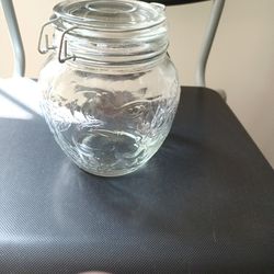 A BALL MASON JAR WITH LEAFS AND FRUITS