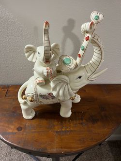 Large ceramic statue features a mother and baby elephant adorned with ceremonial regalia, gold gilding, and faux gemstone details