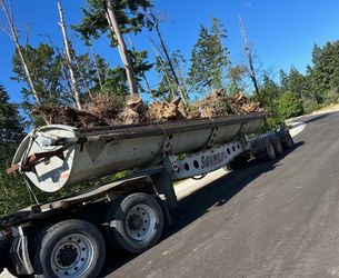 SRB 325 side dump trailer with 2 axles and a drop axle. Heavy-duty trailer built for hauling